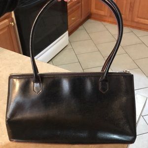 Sleek black handbag with red interior